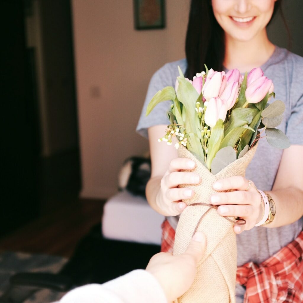 Foto de mulher feliz recebendo flores